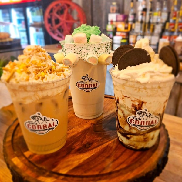 Three Pudgee's Coffee Corral drinks: iced coffee, green milkshake with marshmallows, and an Oreo milkshake.