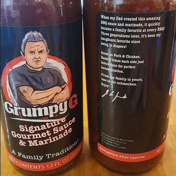 Two bottles of Pudgee's Grumpy G Signature Gourmet Sauce and Marinade with text details.